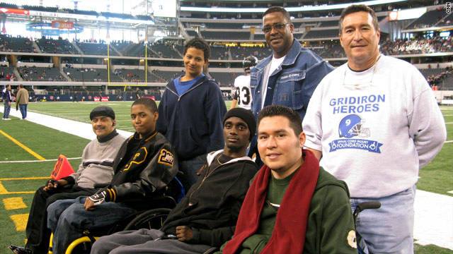 Chris and Eddie Canales with friends on football field